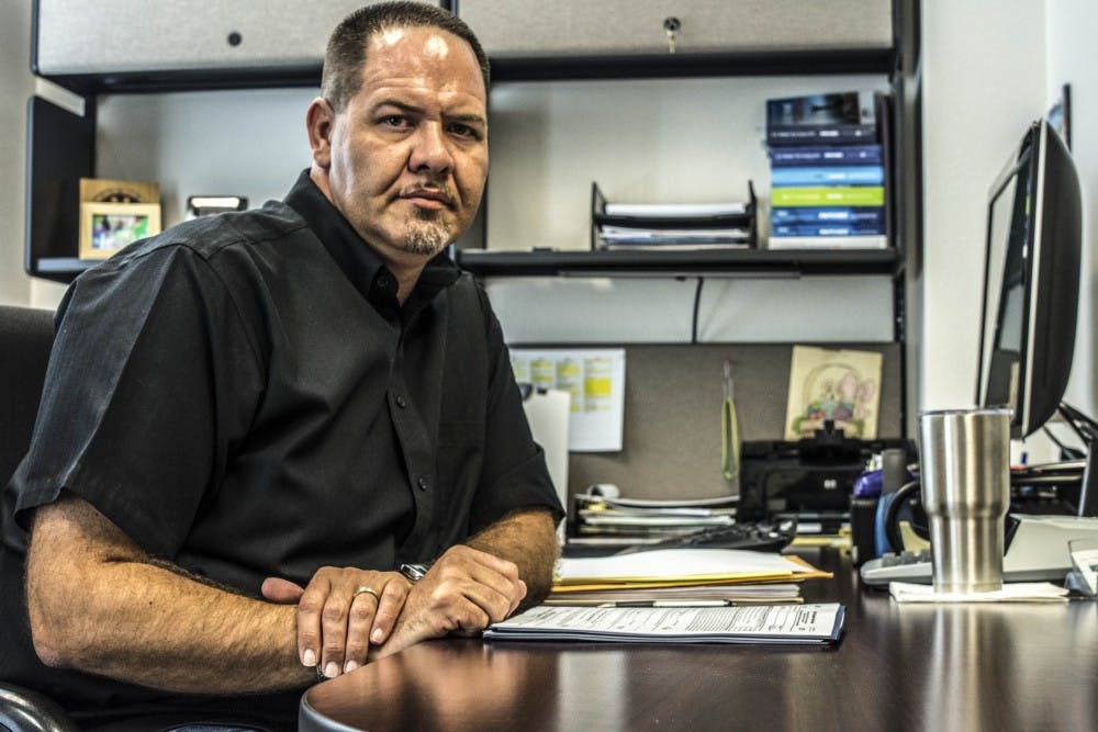 Chad McKinney, CPA, examines paperwork at McKinney & Associates LLC Friday August, 12. McKinney?s firm assists business? bookkeeping, profitability oversight and an array of tax services.