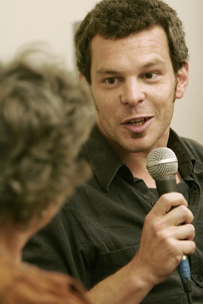 	Micah Kurz, right, talks to Iris Keltz from Channel 27 before his speech in the SUB on Tuesday. Kurz spoke about his experience serving with the Israeli Defense Forces.