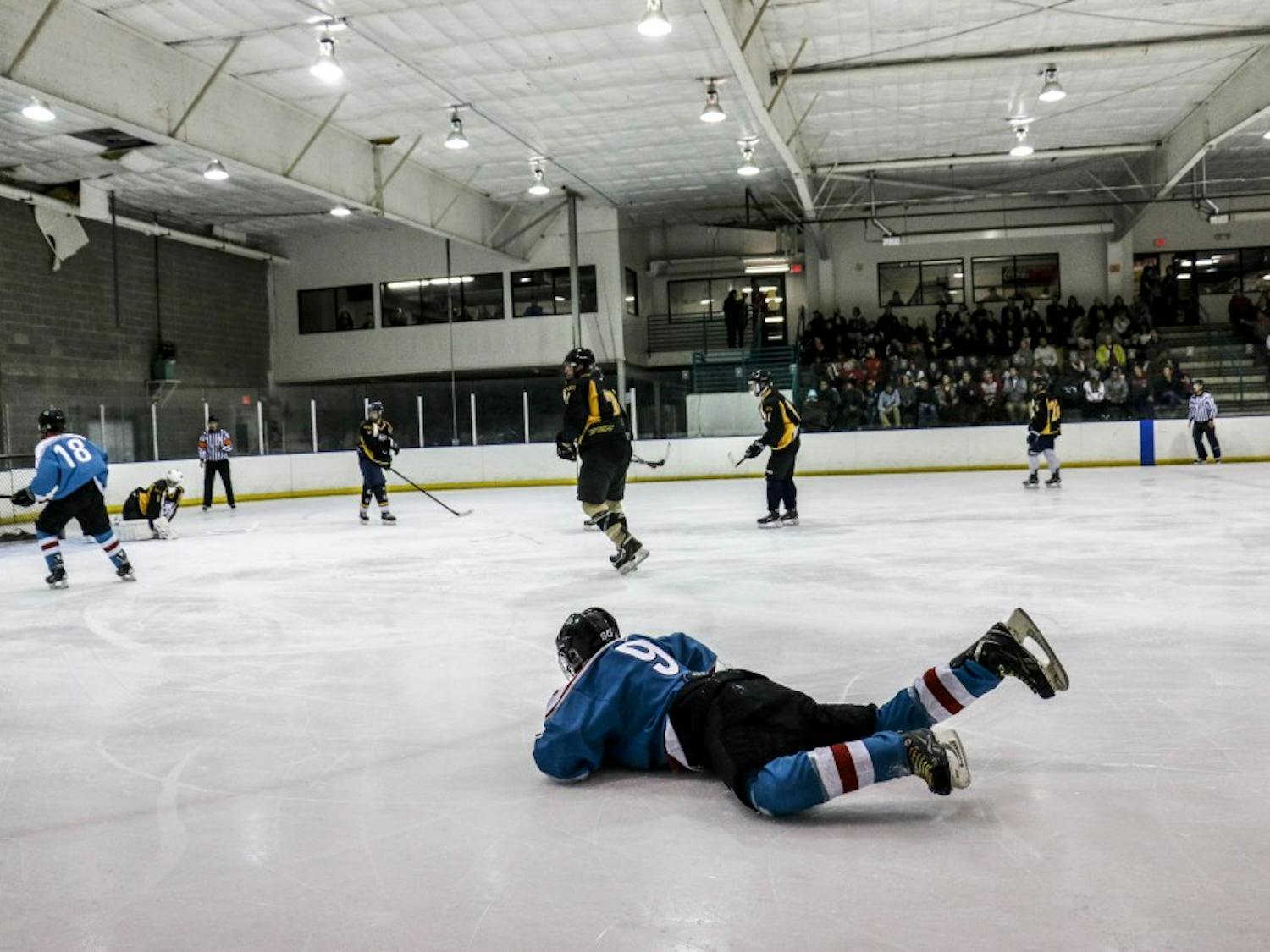 A UNM player takes a fall on the ice during their game against UCCS on their second match of the weekend. The Lobos remain undefeated.&nbsp;