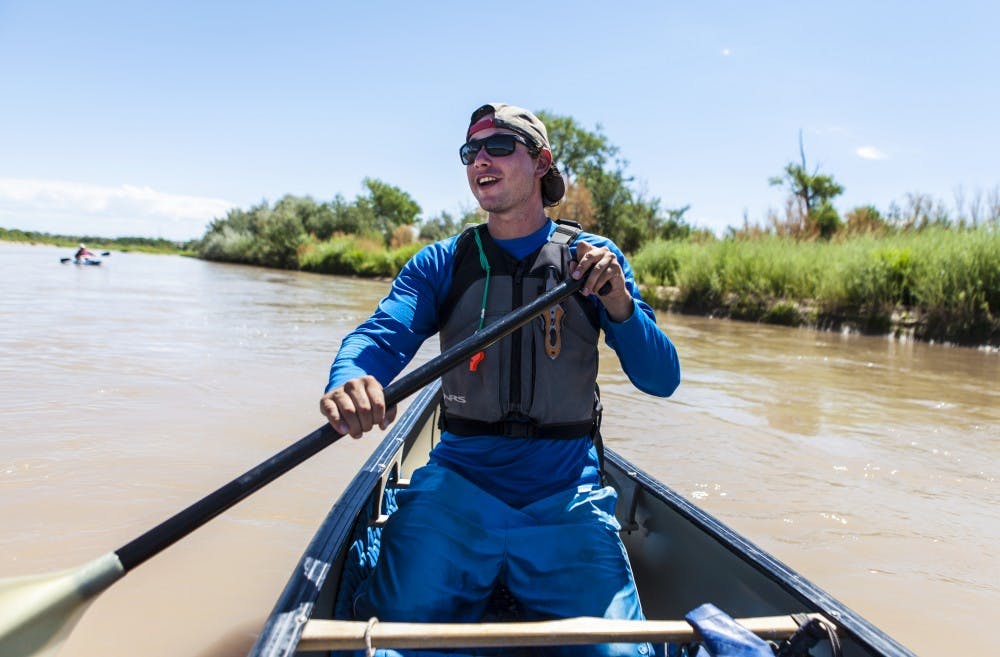 Isek Stotz, river guide for Quiet Rivers, keeps an eye on todays group as they row down river. Stotz says he loves seeing the reactions of those in his groups to the beauty of the river. On Sunday morning a group of enthusiastic people gathered at Quiet Rivers Paddling Adventures in Bernalillo for a tour on the Rio Grande onboard kayaks and canoes.