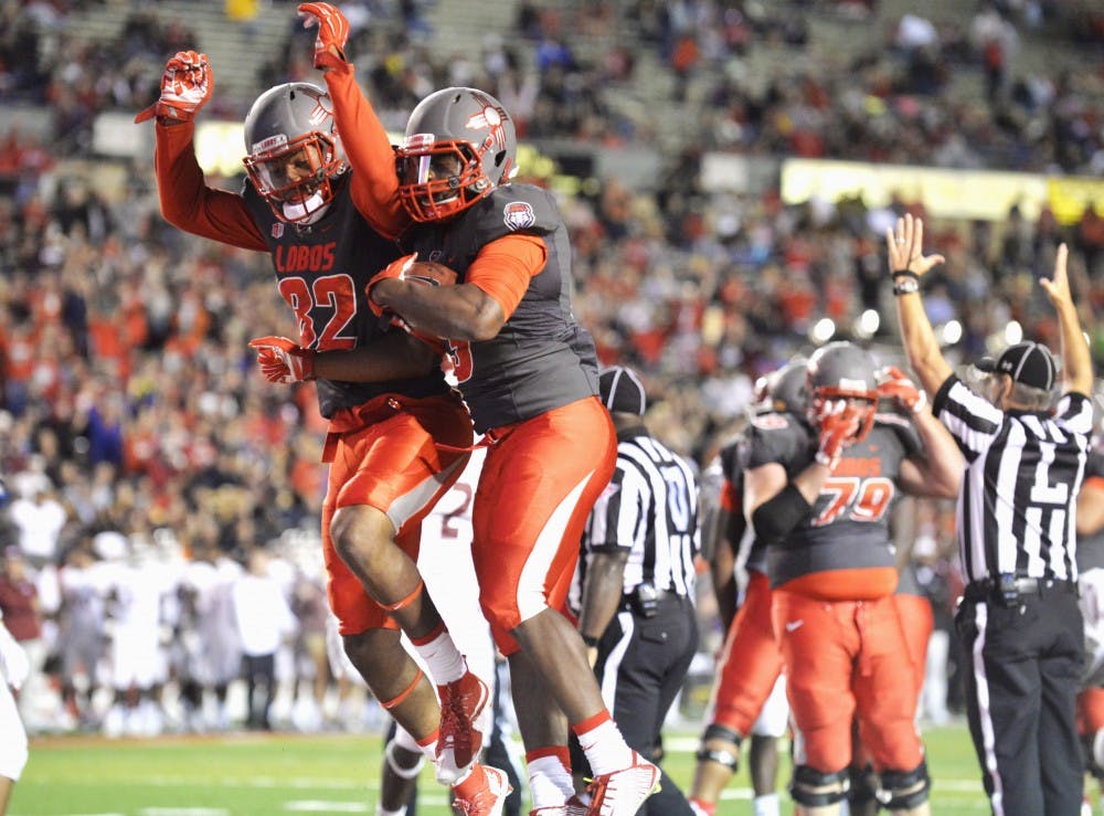 Lobo wide reciever Delane Hart-Johnson (left) and running back Richard McQuarley celebrate moments after McQuarley dove into the end zone Saturday Nov. 3, 2015. The Lobos pulled ahead of the aggies in the fourth quarter, eventually winning 38-29.