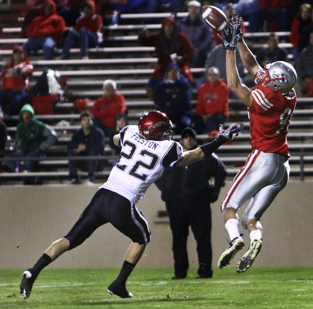 	UNM tight end Lucas Reed catches a pass over SDSU defensive back Andrew Preston in the Lobos’ home loss to the Aztecs 30-20. UNM hosts Wyoming this Saturday at University Stadium.