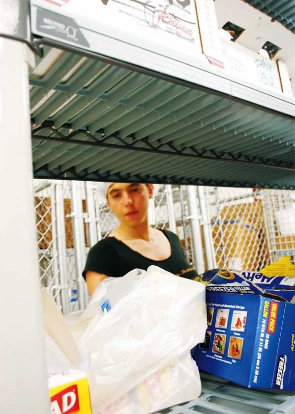 UNM student Ilana Blankman helps in the kitchen at the South Valley Economic Development Center on Sunday. 