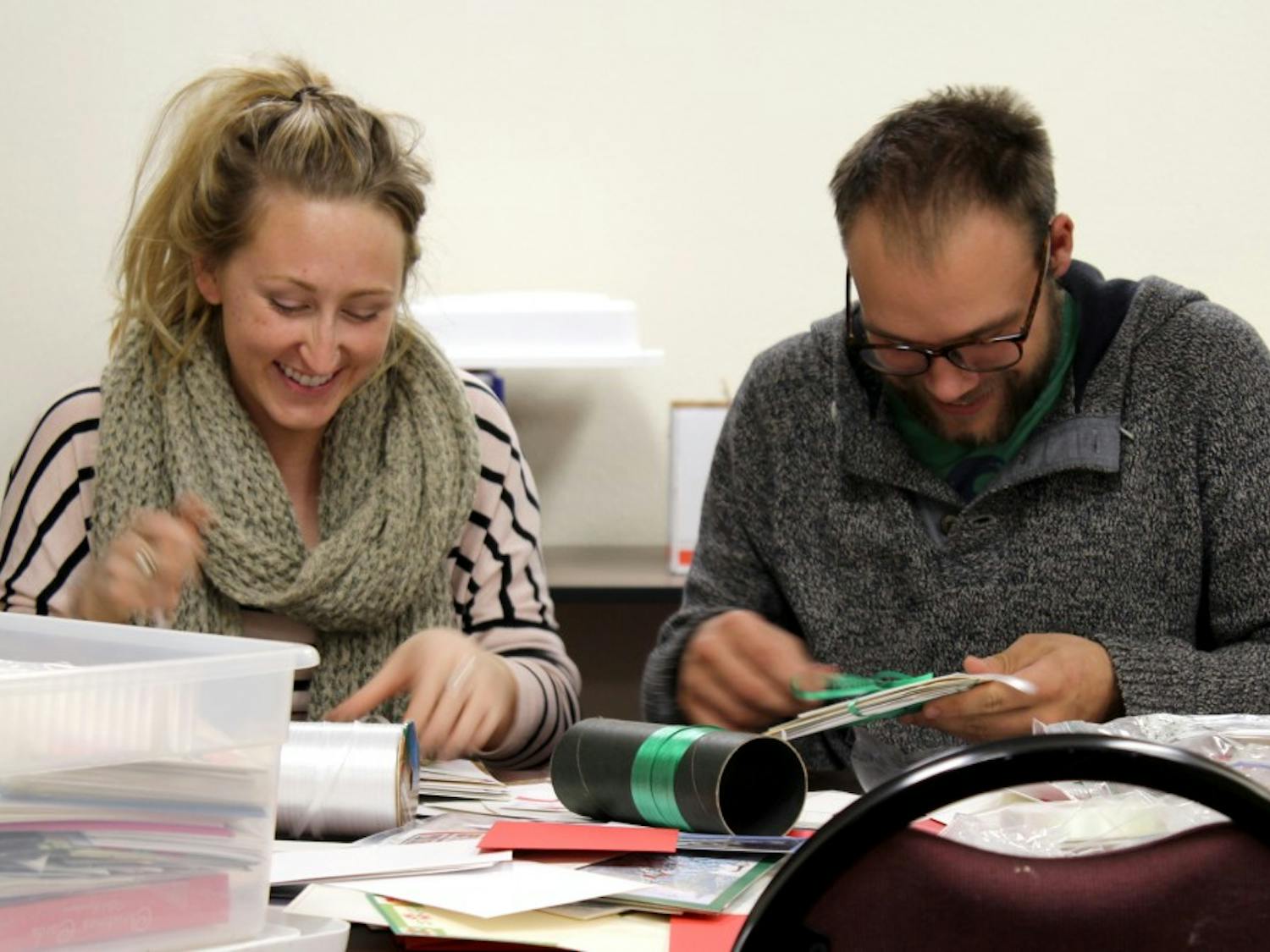 Johannah Maybach, left, and her boyfriend Andrew Stuntz volunteer at their first gift-wrapping event of the season at the UNM Continuing Education building. Maybach is a student from Ft. Lewis, while Stuntz studies at UNM.