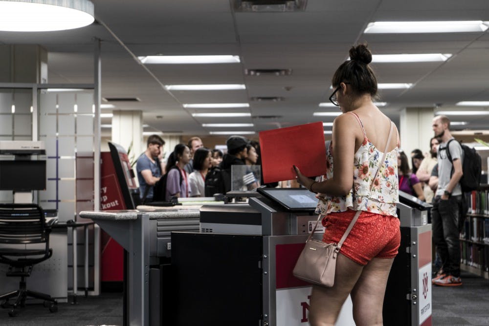 A UNM student uses the new printing stations inside of Zimmerman Library.