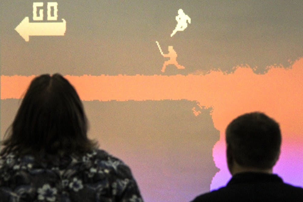 James Green, left, and Joey Hautmann engage in a game of Nidhogg on Friday afternoon for the event, “Dia de Los Juegos,” an event promoted by the student group Local Game Club ABQ. The club aims to bring enthusiastic gamers and game makers together to discuss common interests.