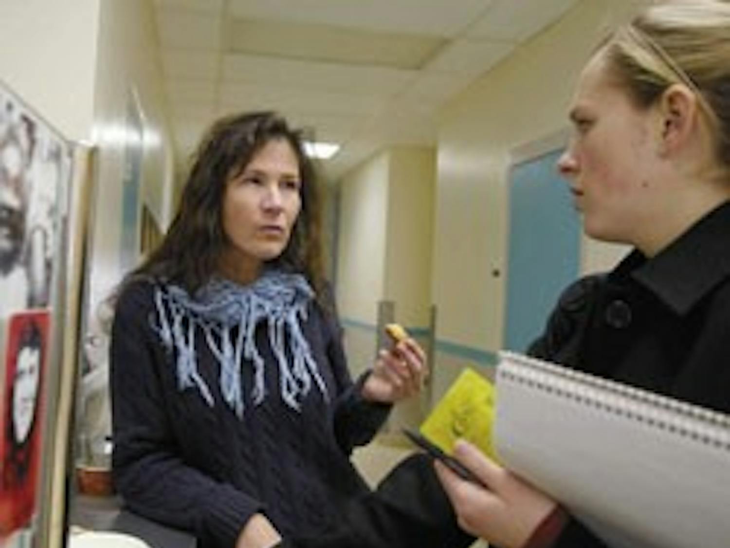 Assistant professor Marie Mugavin, left, talks to public affairs representative Lauren Cruse while getting coffee in the Health Sciences Center on Tuesday. Mugavin was the first nurse to earn a Ph.D. at UNM's nursing school.