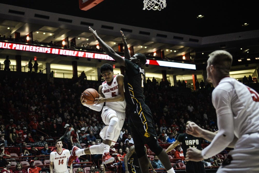 Freshman guard Jalen Harris jumps past a Arkansas-Pine Bluff defender Saturday, Dec. 17, 2016 at WisePies Arena. The Lobos will face off with Utah State this Wednesday.