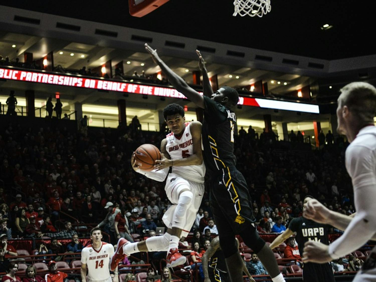 Freshman guard Jalen Harris jumps past a Arkansas-Pine Bluff defender Saturday, Dec. 17, 2016 at WisePies Arena. The Lobos will face off with Utah State this Wednesday.