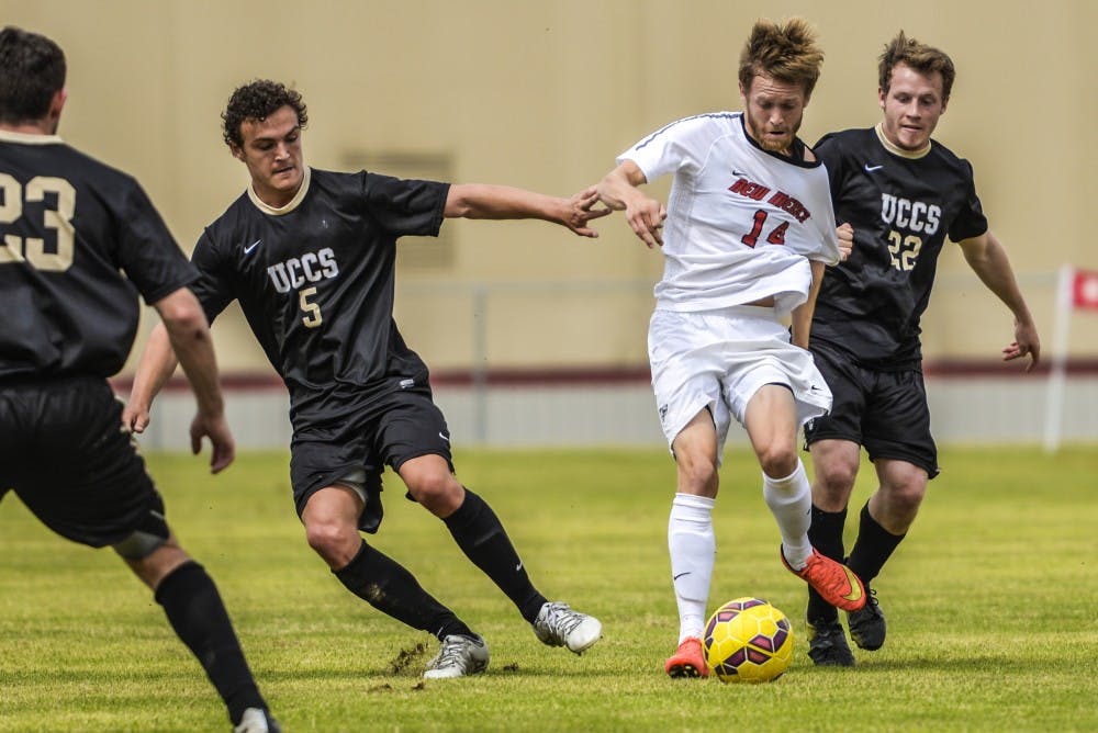 Redshirt senior mid fielder Chris Wehan fights off UCCS players Saturday morning at Robertson Field. The Lobos beat the Mountain Lions 1-0.