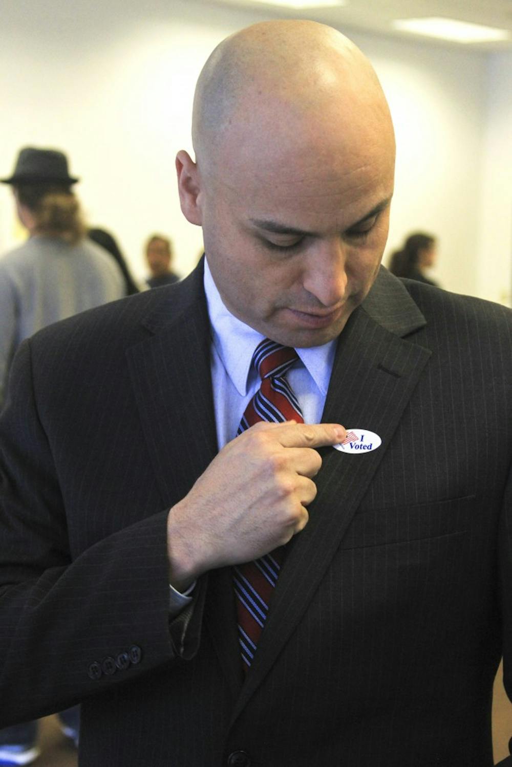 Hector Balderas, the Democratic candidate for attorney general, places an “I voted” sticker on his lapel after voting Tuesday morning at the West Bluff polling center. Balderas defeated Republican candidate Susan Riedel for the attorney general’s seat.