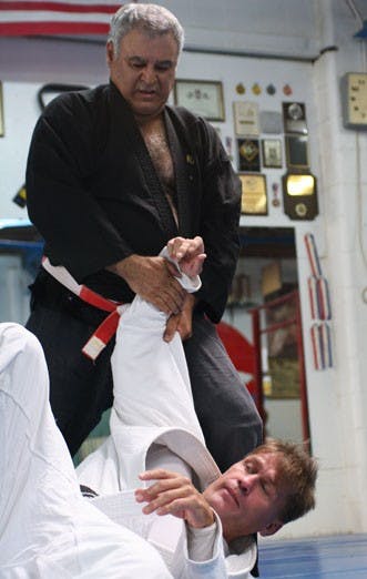Andrew Yiannakis performs a jujutsu move on Andrew Frye Saturday at Sandia Judo Club. Yiannakis is teaching jujutsu this semester at UNM. 