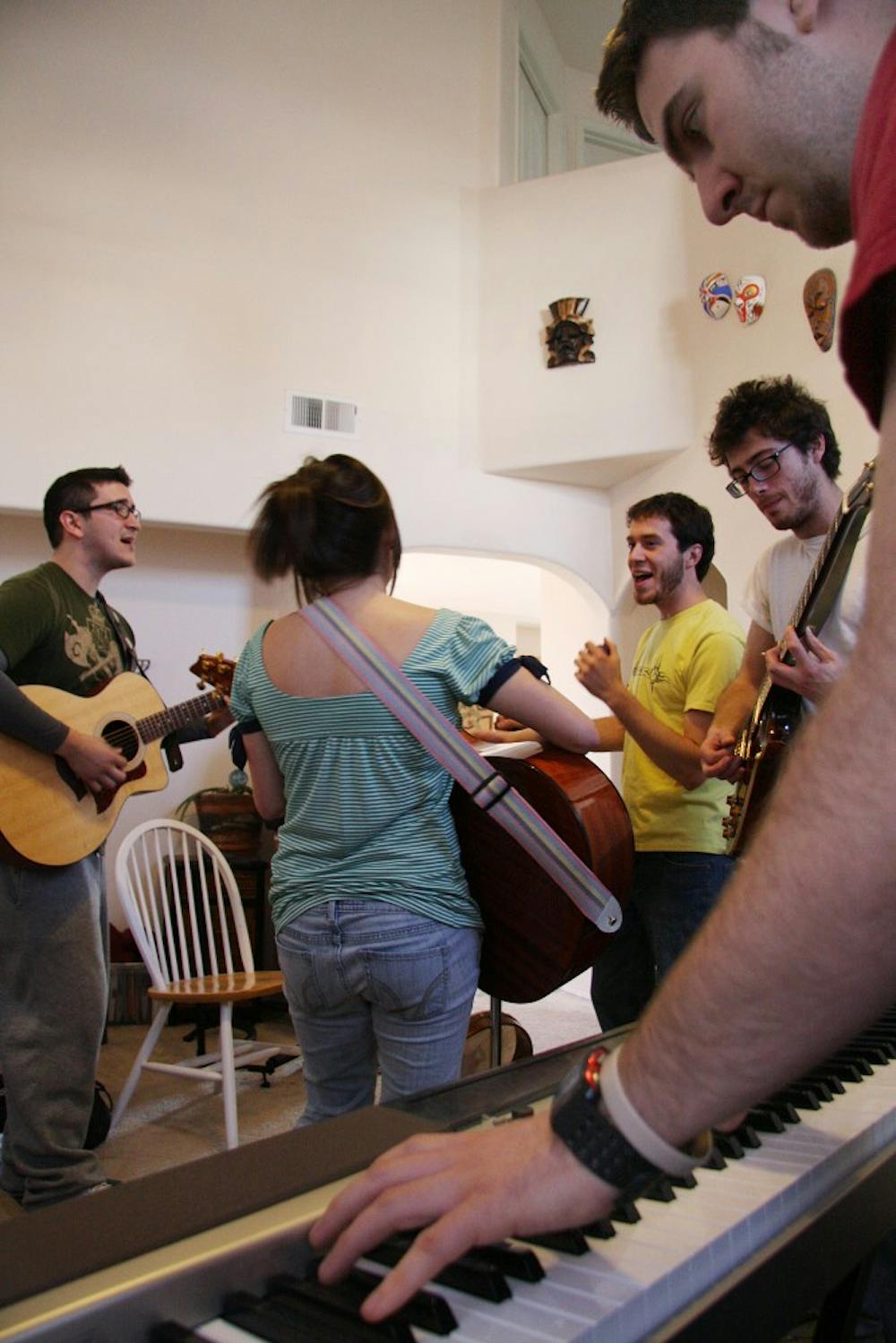 	From left, Mike Mares, Michelle Baumann, Jesse Herrera, Greg Pisotti, and Josh Herrera rehearse a song, on Saturday, during an all-day writing and practicing session for their band The Noms. The band won UNM’s Battle of the Bands in 2009.
