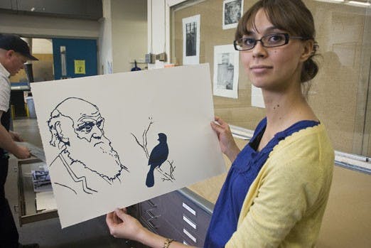 Jessica Gross displays a print she made in honor of Charles Darwin's 200th birthday in the Fine Arts Building on Thursday. 