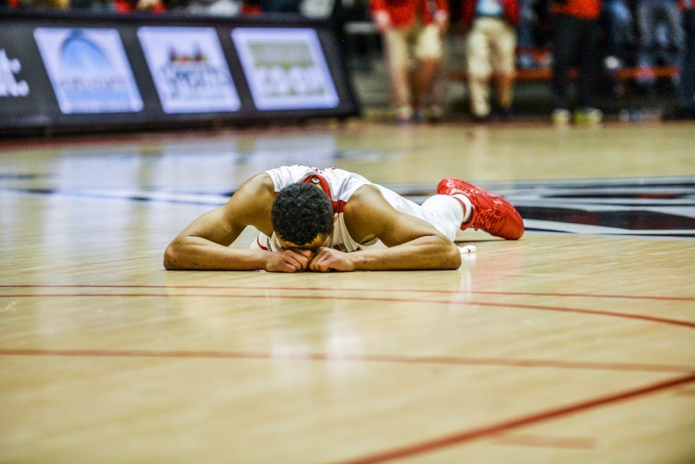 Redshirt junior guard Elijah Brown lays face down on the court after missing a last minute buzzer shot Saturday, Jan. 7, 2016 at WisePies Arena. The Lobos lost to Nevada University 105-104 in overtime.&nbsp;