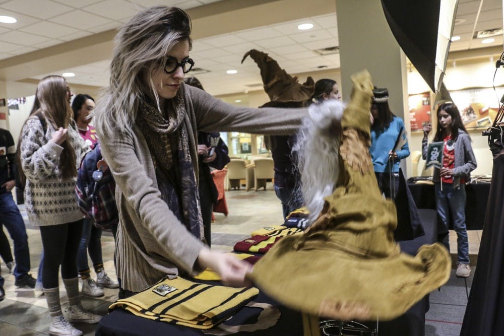 UNM students dig through Harry Potter themed props to wear before taking pictures in a photo booth at the UNM Harry Potter Day held annually in the Student Union Building on Nov. 20, 2018.