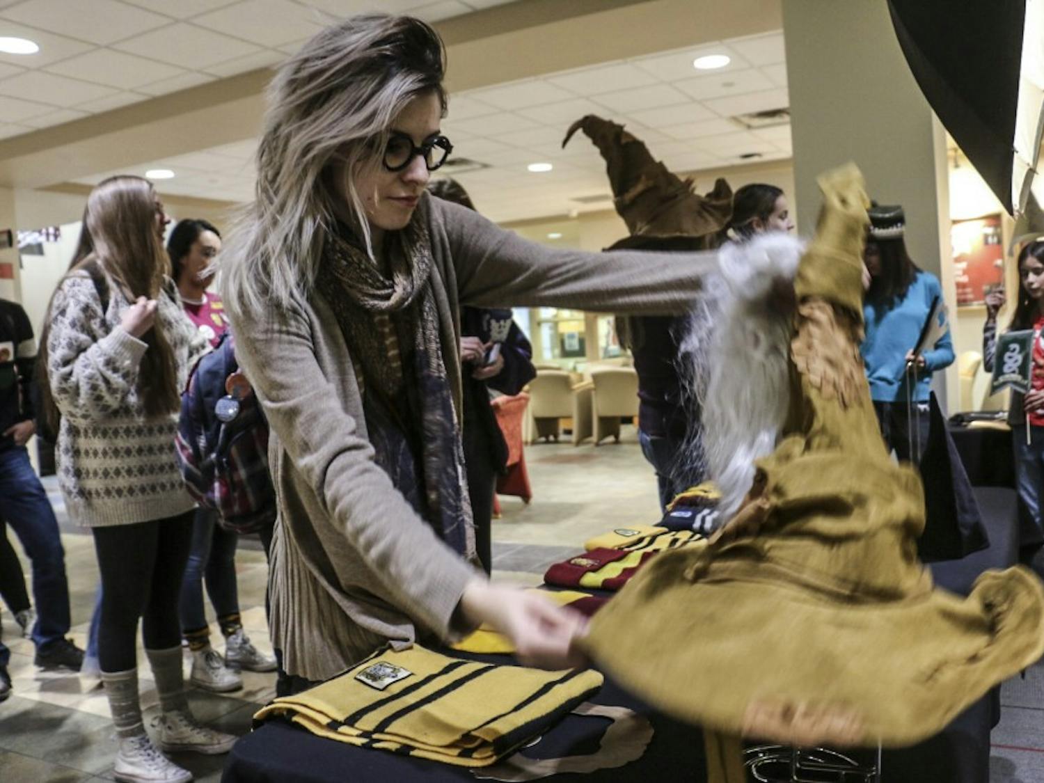 UNM students dig through Harry Potter themed props to wear before taking pictures in a photo booth at the UNM Harry Potter Day held annually in the Student Union Building on Nov. 20, 2018.