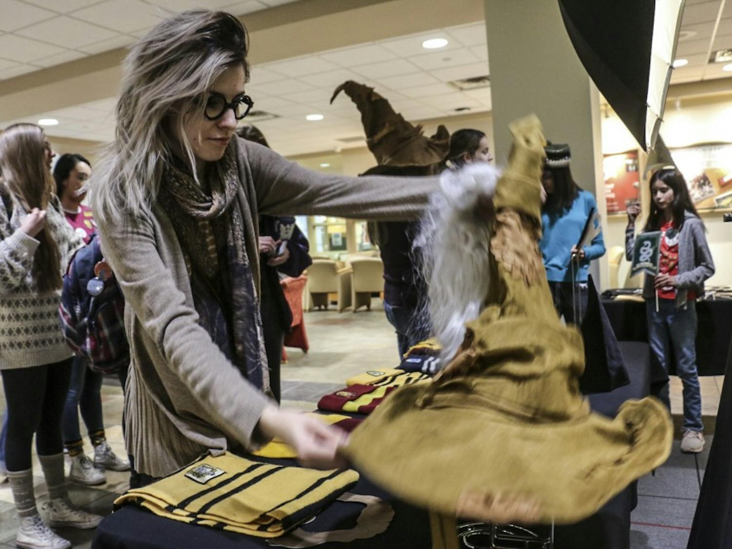 UNM students dig through Harry Potter themed props to wear before taking pictures in a photo booth at the UNM Harry Potter Day held annually in the Student Union Building on Nov. 20, 2018.