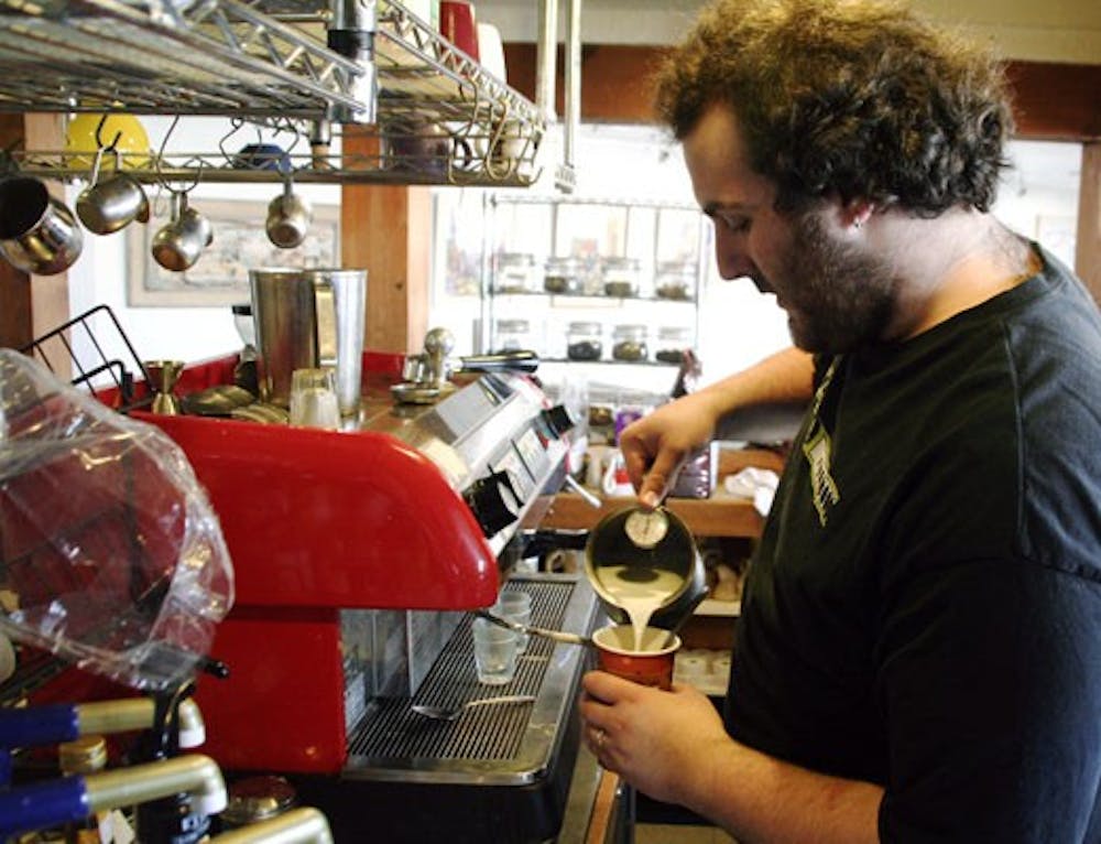 Owner Brian Rosen makes a peppermint mocha latte at Blue Dragon Coffeehouse on Monday. The coffee shop re-opened March 1.