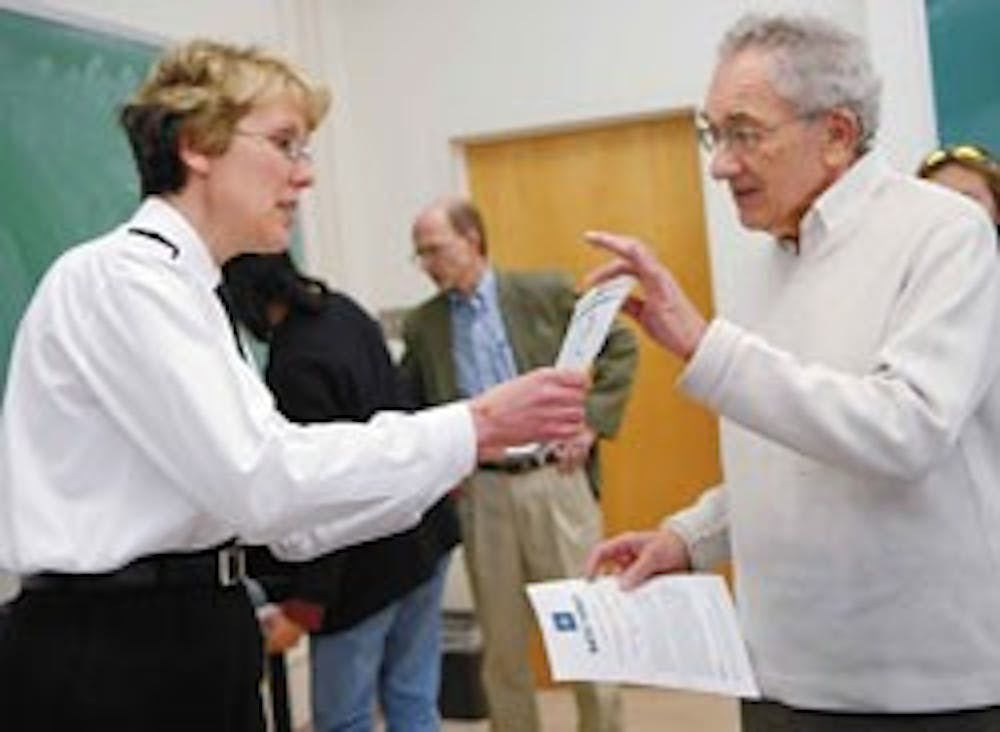 Royal Navy Lt. Commander Tania Price, left, talks to Bernard Udis after giving a presentation about NATO's goals Monday in Mitchell Hall.  