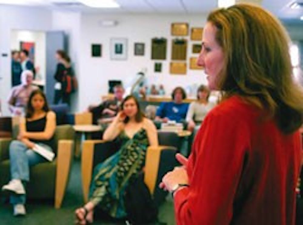 Mary Vosevich, chairwoman of the Sustainability Task Force, talks to students about implementing energy-efficient policies at the University during a forum in the Honors Forum Lounge on Thursday.  