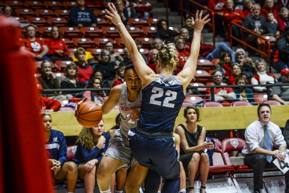 Junior guard Jayda Bovero looks past a Utah State defender Wednesday, Jan. 4, 2016 at WisePies Arena. The Lobos will face off with Nevada University this Saturday.&nbsp;