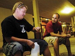 Tool fan Brian McMath, left, checks the time while he waits with Nathan Sparks in front of Hastings on Lomas Boulevard for the midnight release of Tool's new album, 10,000 Days, on Monday night. 
