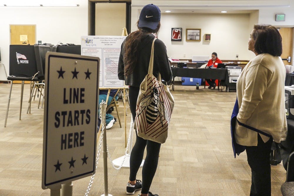 A voter and a poll worker stand in front of the UNM early voting station on the third floor of the SUB. Early voting will conclude this Friday at 8 p.m..