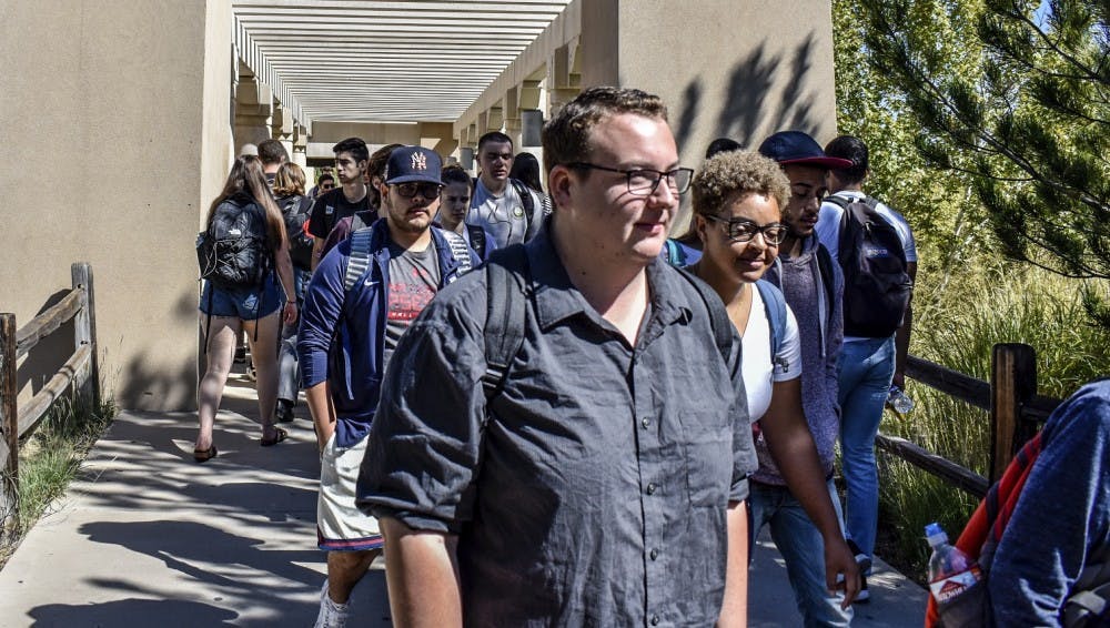 University of New Mexico students continue their day leaving, or arriving to Dane Smith Hall. Of the almost 24,000 students at UNM, less than six percent use the Lobo Guardian app.