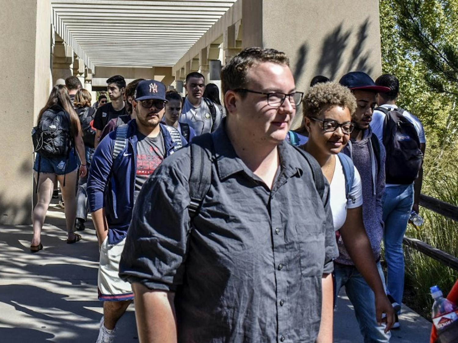 University of New Mexico students continue their day leaving, or arriving to Dane Smith Hall. Of the almost 24,000 students at UNM, less than six percent use the Lobo Guardian app.