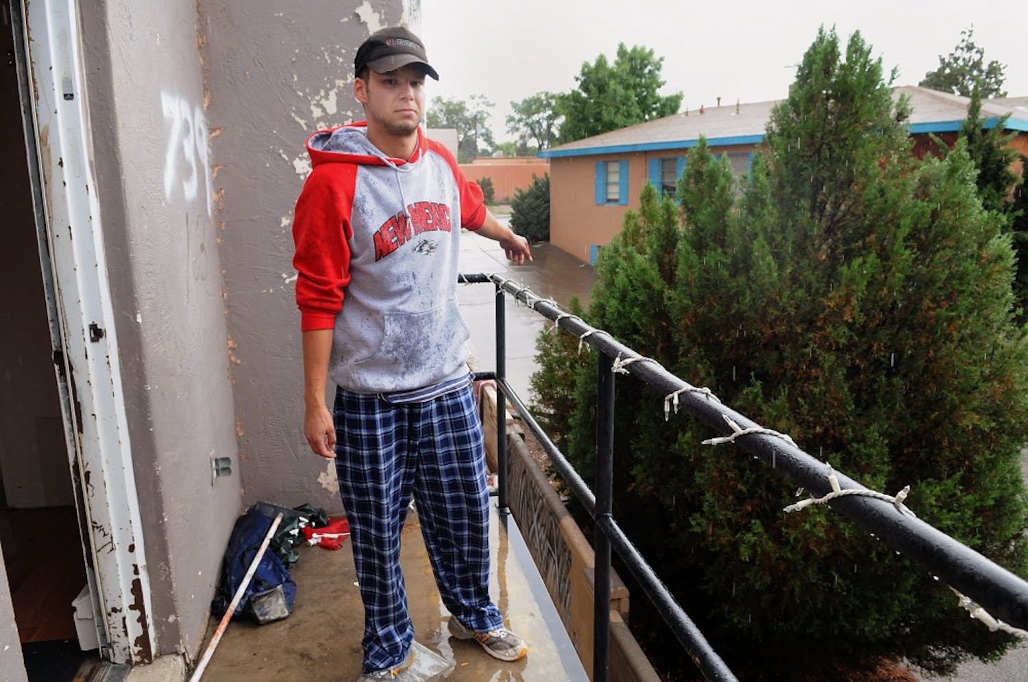 	UNM business student Alexander Heubeck points to the balcony he jumped off of to avoid a fire in the Telos House on Thursday. One room in the house caught fire at about 2:50 a.m. No one was injured. The Telos houses have caught fire four times in the past 14 months.