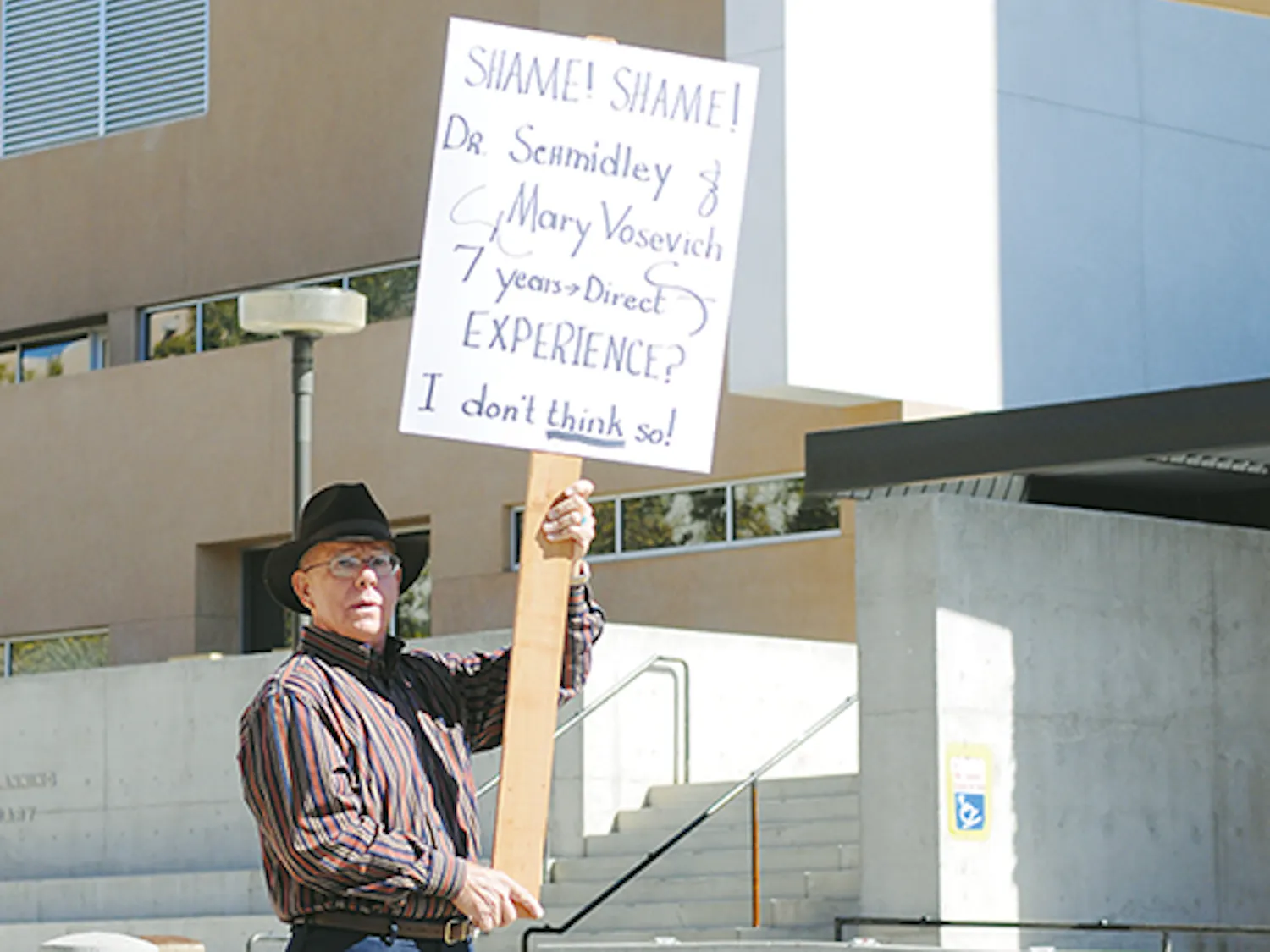 Bob Harris protests the hiring of President David Schmidly's son, Brian, on Sunday in front of the Bookstore. Brian Schmidly was hired as associate director of sustainability Wednesday but withdrew his application Sunday.