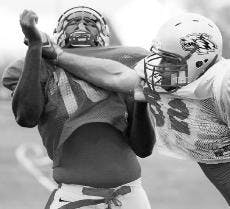 Zayn Bin-Bilal, left, adn Phillip Harrison run drills at Wednesday's practice.