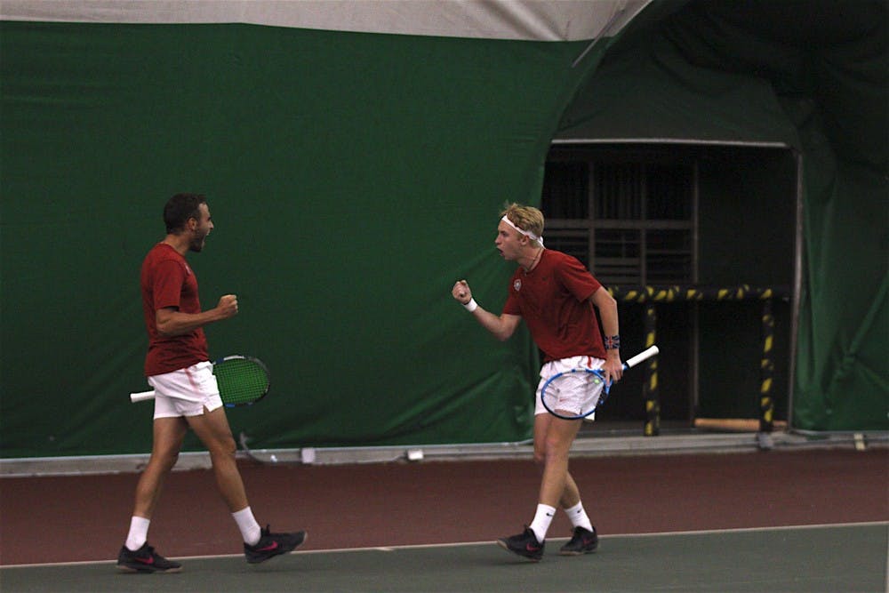 Dominic West and Sean Baklini celebrates together during a doubles mens tennis match against Utah Sate on April 13, 2018.&nbsp;