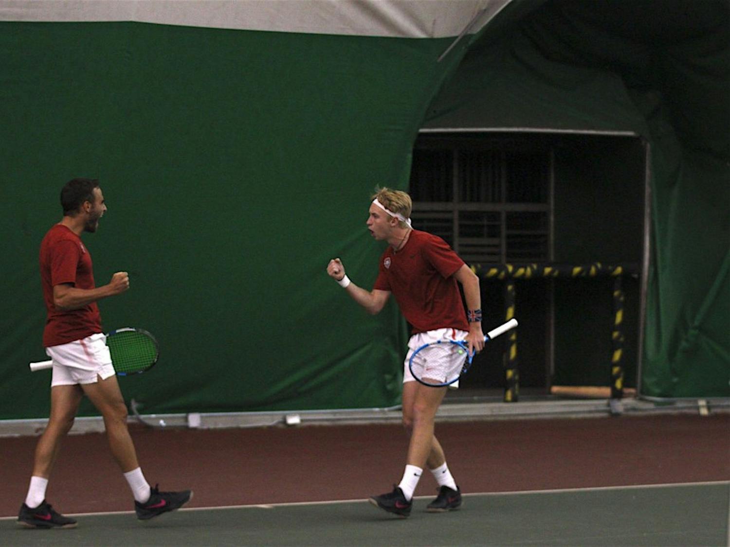 Dominic West and Sean Baklini celebrates together during a doubles mens tennis match against Utah Sate on April 13, 2018.&nbsp;