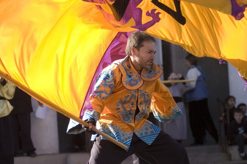 Ernest Armijo waves a flag during a dress rehearsal at the Chinese Cultural Center on Saturday. The center, at 427 Adams St. S.E., will host a New Year's celebration Saturday to usher in the Year of the Rat.