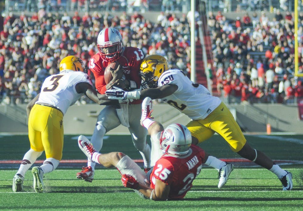 	New Mexico redshirt freshman quarterback Lamar Jordan attempts to rush toward the end field during the Lobo football game against Arizona State at University Stadium on Saturday night. The Lobos lost 23-58.