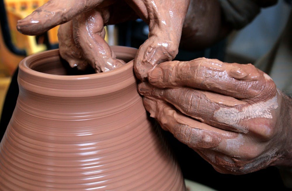 	Patrick Trujillo molds a pot in his studio, Not Made in China. Studio space is available for $50 a month.