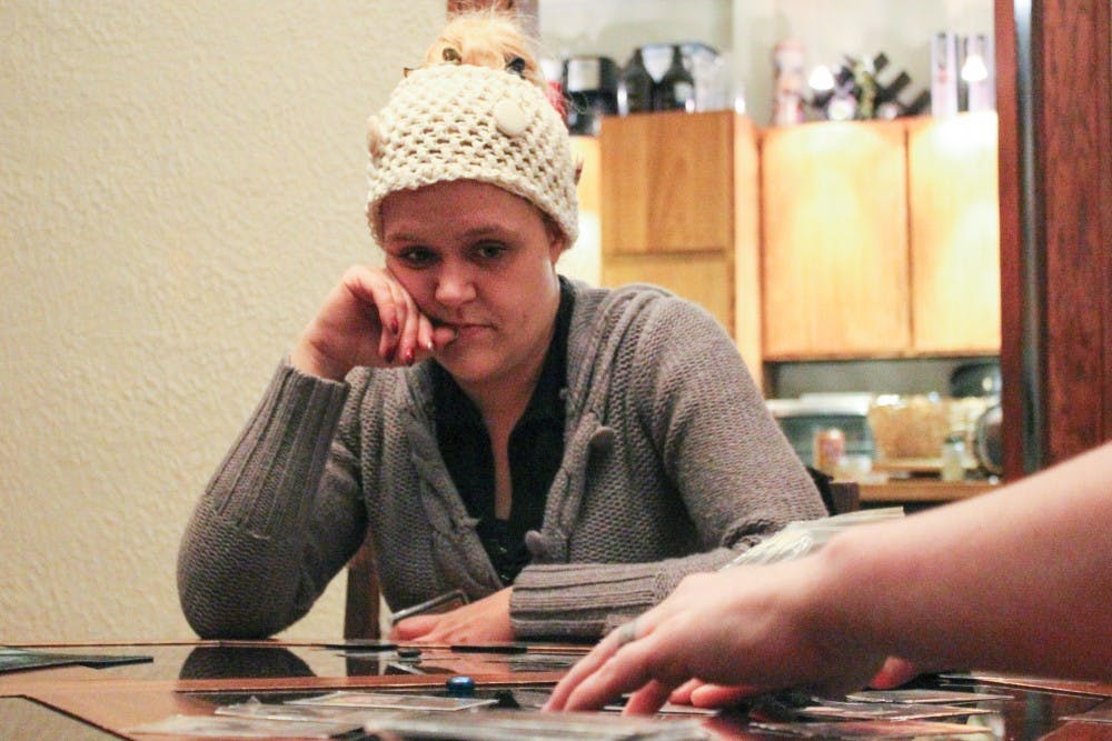 Gwen Maitreya plays the card game Magic: The Gathering Friday night with friends. Magic: The Gathering is a fantasy-based tradable card game, where opponents seek to outdo each other in order to win.