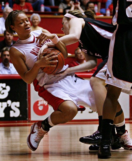 UNM guard Georonika Jackson falls while San Diego's Allison Duffy grabs the ball during Wednesday's 63-54 win at The Pit.  
