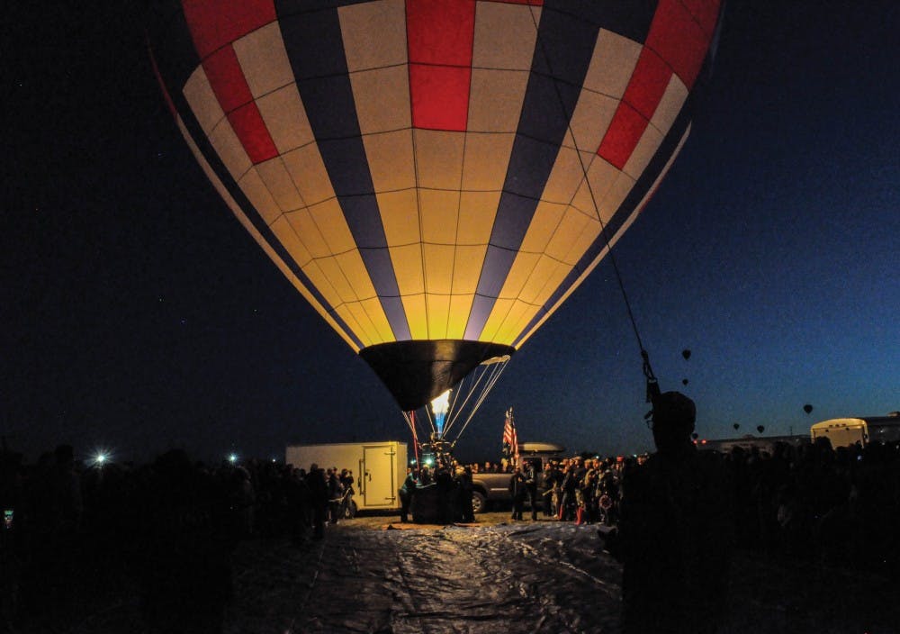 Balloon Fiesta teams set their balloons aglow during the dawn patrol show on Saturday, Oct. 14, 2017. 
