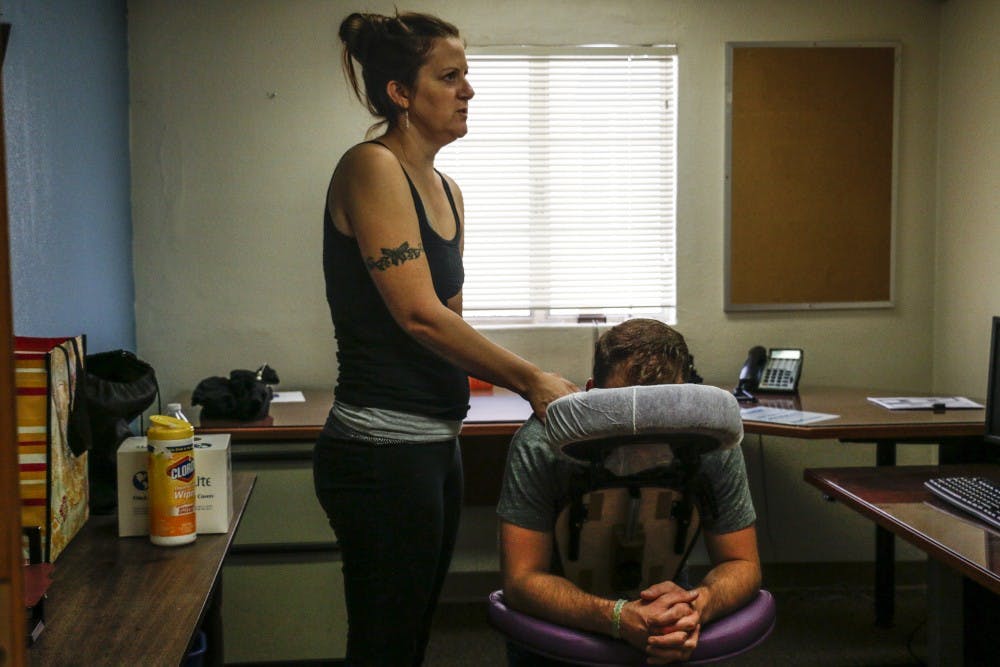 Rebeca Hummell gives a massage to Kyle Stepp during the OEO Open house on Wed. 4, 2016. OEO's&nbsp;open house lasted from 8 am to 11:30 where food and massages were given to students, staff, or anyone who went in.