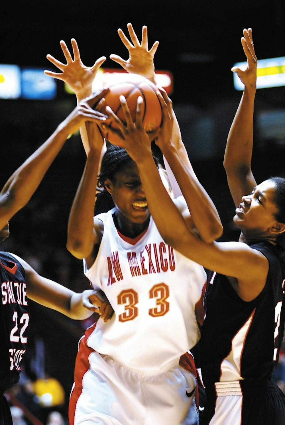 UNM forward Dionne Marsh	 fights for a rebound in the first half of Wednesday's game at The Pit. The Lobos won 76-46.