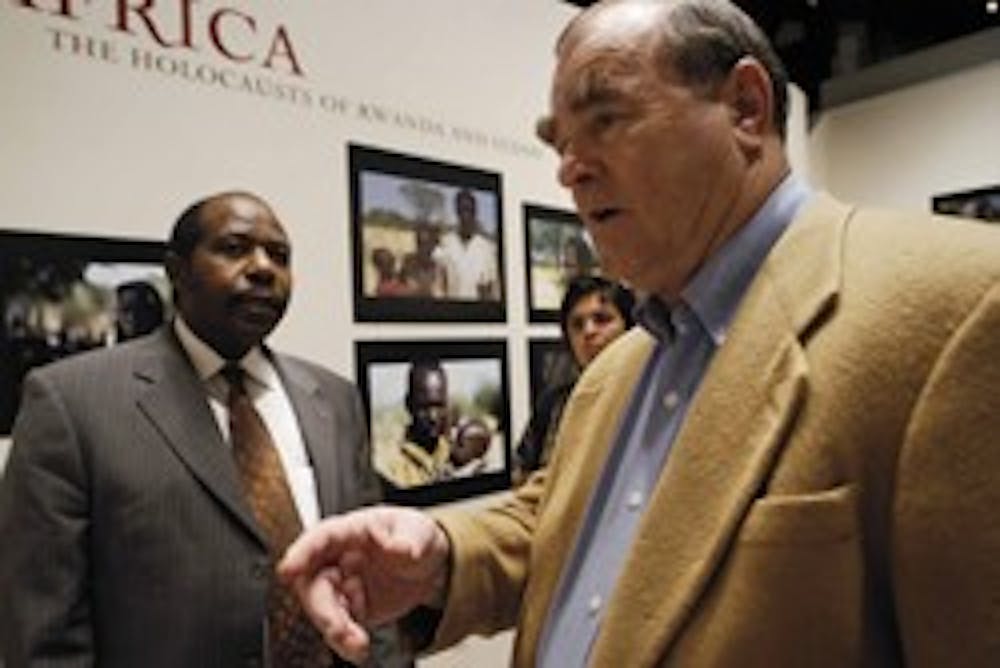 Paul Rusesabagina, left, the man who inspired the film "Hotel Rwanda," and photographer Lucian Niemeyer look through Niemeyer's exhibit, Africa: The Holocausts of Rwanda and Sudan, Saturday in the Maxwell Museum.  