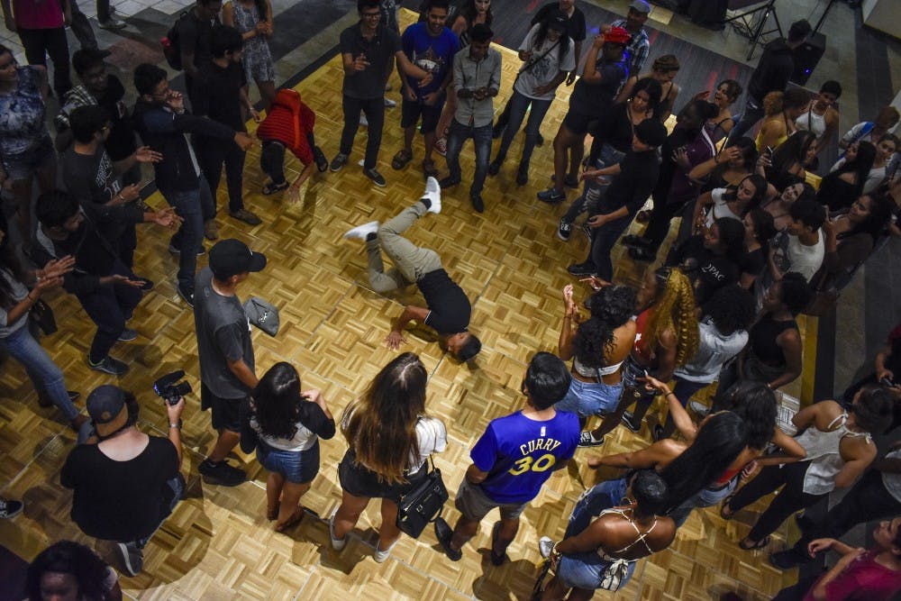 Students gather to watch a student break dance in the lower level of the Student Union Building during Friday Night Live on Aug. 17.