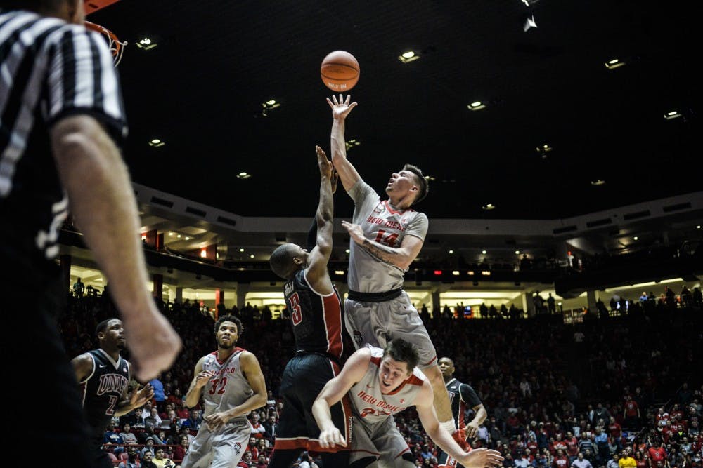 Sophomore guard Dane Kuiper jumps over fellow teammate Joe Furstinger and UNLV players on his way to the net Tuesday, Jan. 10, 2017 at WisePies Arena. The Lobos beat Colorado State this Saturday 84-71.
