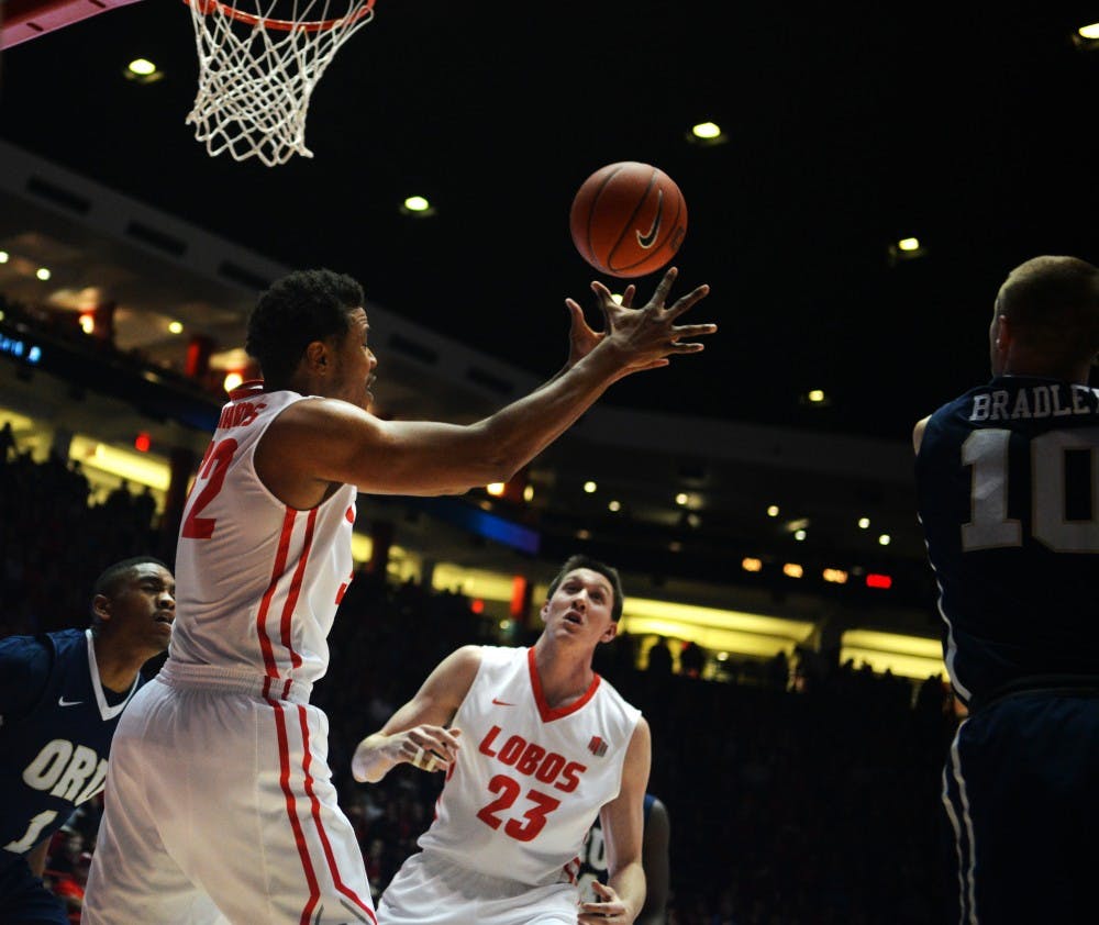 Redshirt junior Tim Williams (left) reaches out for a rebound against Oral Roberts at WisePies Arena Dec. 1. The Lobos are scheduled to play Purdue Saturday December 5 in Indiana.&nbsp;