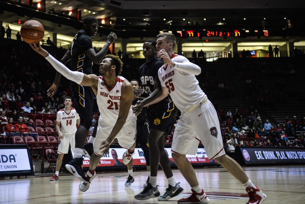 Junior guard Xavier Adams lunges towards the net Saturday, Dec. 17, 2016 at WisePies Arena. The Lobos will attempt their 7th at home win against Fresno State this Wednesday at WisePies Arena.&nbsp;
