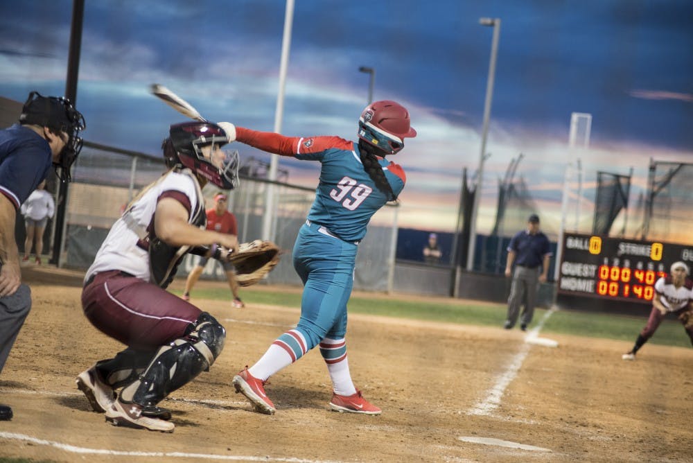 Day'Mian Johnson swings at a pitch during Wednesday night's rivalry matchup between the Lobos and the New Mexico State Aggies at Lobo Softball Field. Johnson, a freshman, recorded the first hit of her career. The Aggies won 12-7.