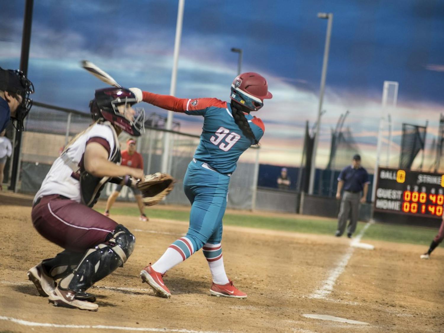 Day'Mian Johnson swings at a pitch during Wednesday night's rivalry matchup between the Lobos and the New Mexico State Aggies at Lobo Softball Field. Johnson, a freshman, recorded the first hit of her career. The Aggies won 12-7.